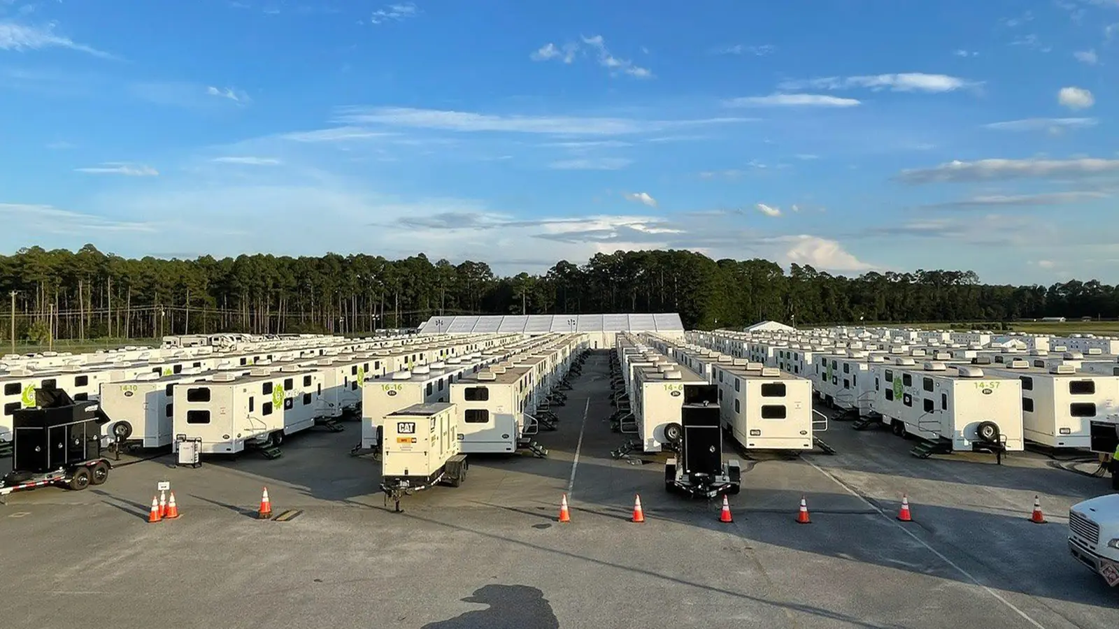 Rows of sleeper trailers staged on a hardstand at a workforce camp