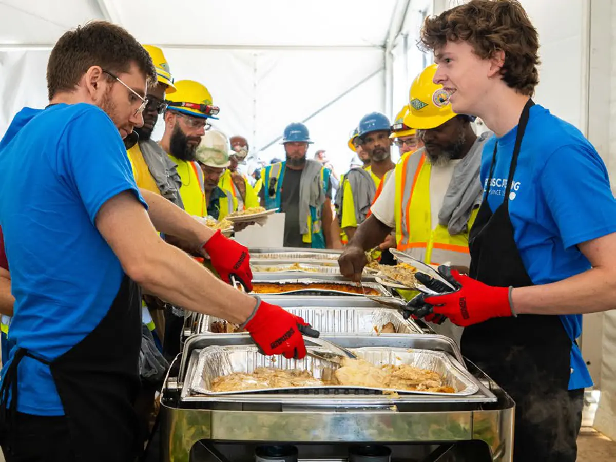 Catering crew serving hot meals on site